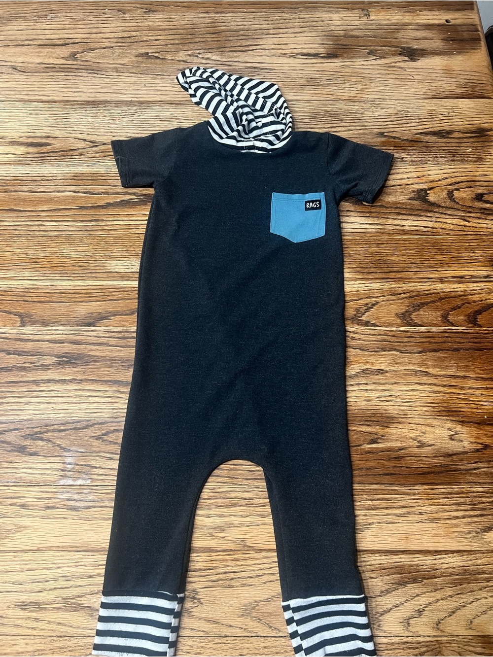 Black Kids One-Piece Bodysuit with Blue Pocket and Striped Hood
